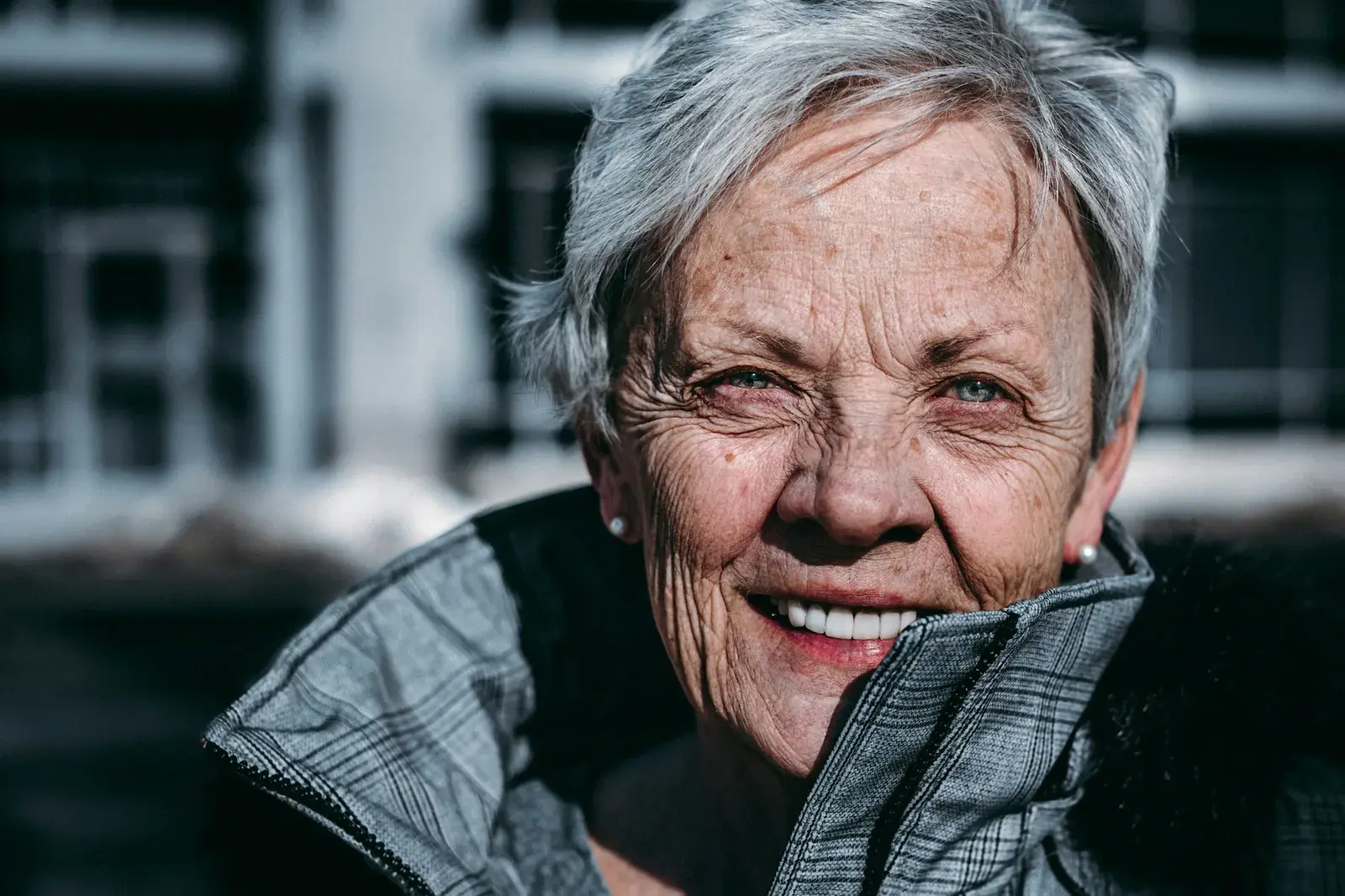 Elderly woman smiling, natural teeth in focus (Unsplash photo)